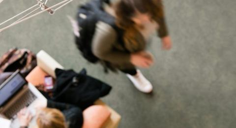 UNH students walking inside campus building to class